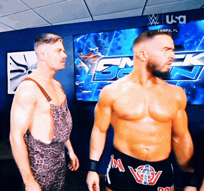 two wrestlers are standing in front of a screen that says tampa fl