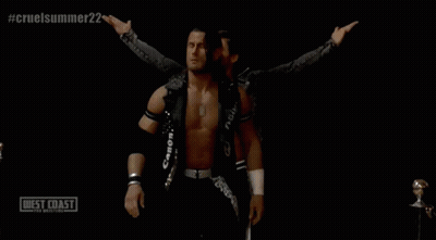 Two Wrestlers Are Standing In Front Of A Sign That Says West Coast Wrestling GIF