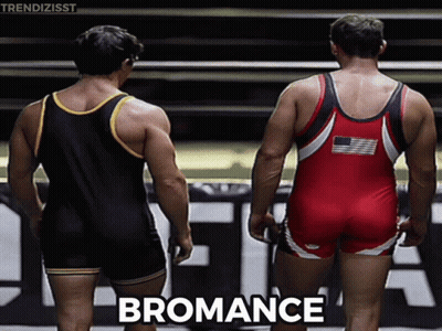 Two Wrestlers Are Standing Next To Each Other And The Word Bromance Is On The Bottom Right GIF