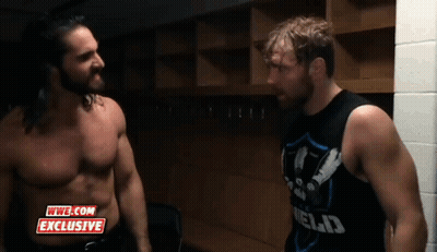 Two Wrestlers Are Standing Next To Each Other In A Locker Room With A Wwe.com Exclusive Logo On The Bottom GIF