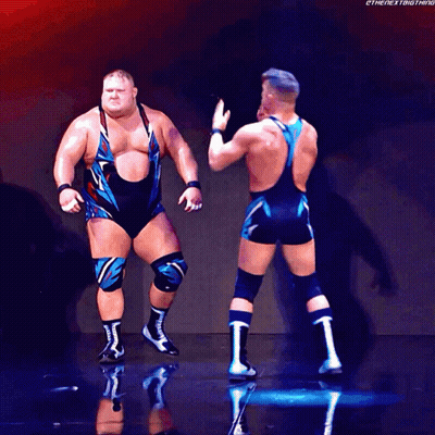 Two Wrestlers Are Standing Next To Each Other With The Hashtag Thenextbigthing GIF
