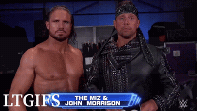 Two Wrestlers Are Standing Next To Each Other With The Miz And John Morrison Written On The Screen Behind Them GIF