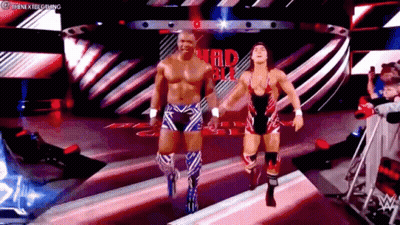 Two Wrestlers Are Walking Down A Ramp In A Wrestling Ring . GIF