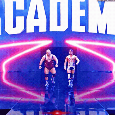 Two Wrestlers Are Walking On A Stage In Front Of A Sign That Says Cadem GIF
