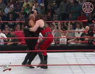 Two Wrestlers Are Wrestling In A Ring With A Pentagram On The Ring GIF