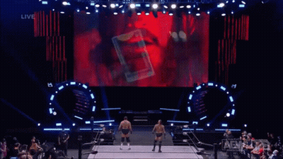 Two Wrestlers Before Screen Saying Live GIF