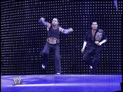Two Wrestlers Dancing In Front Of W Wall GIF