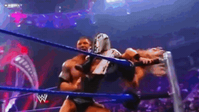 Two Wrestlers Fighting In Ring With Crowd Watching GIF