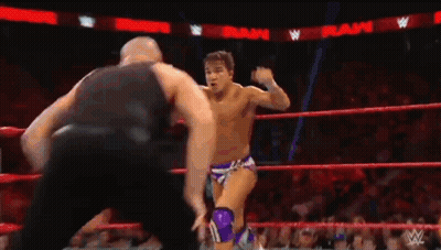 Two Wrestlers Fighting In Ring With Referee GIF
