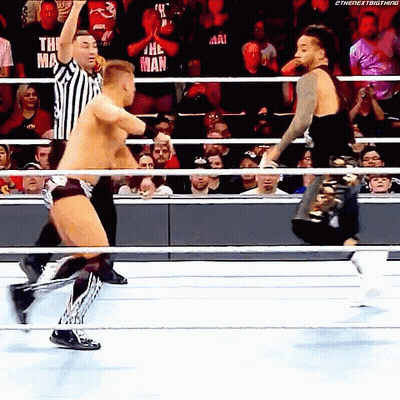Two Wrestlers Fighting In Ring With Referee GIF