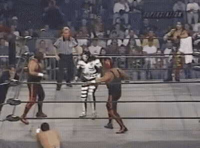 Two Wrestlers Fighting In Ring With Referee GIF