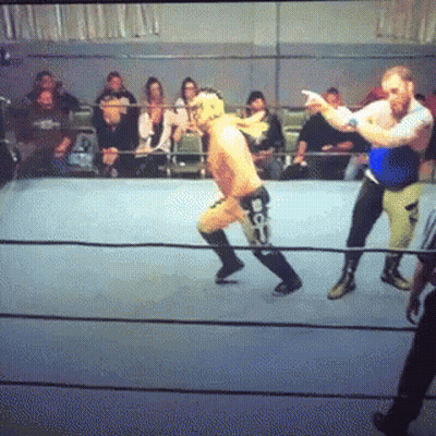 Two Wrestlers Fighting In Ring With Referee GIF