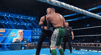 Two Wrestlers Fighting In Ring With Smack Banner GIF