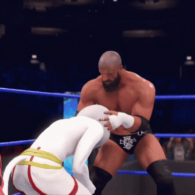 Two Wrestlers In A Ring With One Wearing A Belt That Says U. GIF