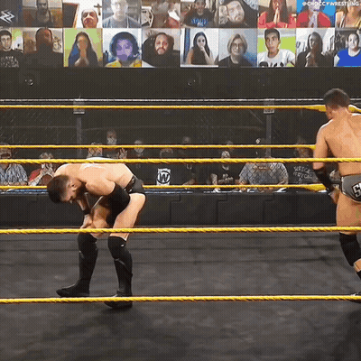 Two Wrestlers In A Wrestling Ring With A Screen Behind Them That Says ' Chicago Wrestling ' On It GIF