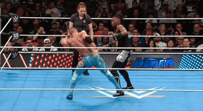 Two Wrestlers In A Wrestling Ring With A Sign That Says Main On It GIF