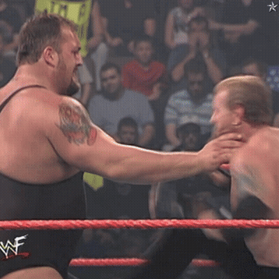 Two Wrestlers In A Wrestling Ring With A Wwe Logo On The Ropes GIF