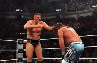 Two Wrestlers In A Wrestling Ring With One Wearing A Pair Of Shorts With The Letter P On Them GIF