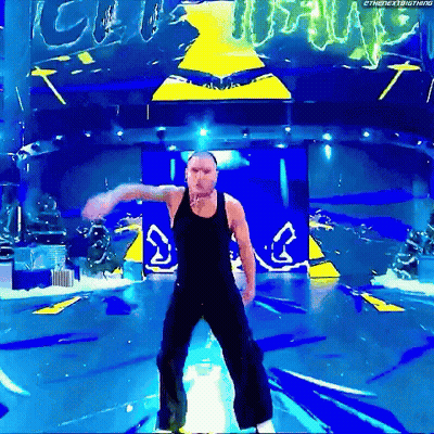Two Wrestlers In Front Of Ladder Match Banner GIF