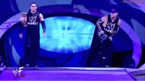 Two Wrestlers In Front Of Live Screen GIF