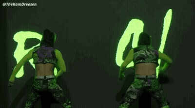 Two Wrestlers In Front Of Neon Sign Saying RS / IL GIF