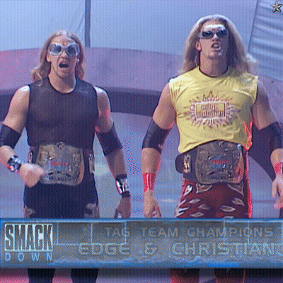 Two Wrestlers In Front Of SmackDown Sign GIF