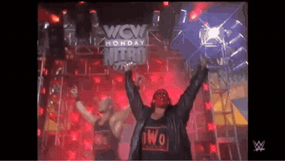 Two Wrestlers In Front Of Wow Monday Nitro Sign GIF