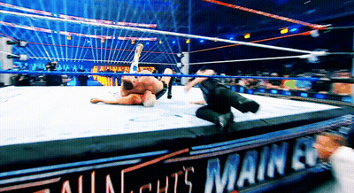 Two Wrestlers in Ring With All Nights Main Event Sign
