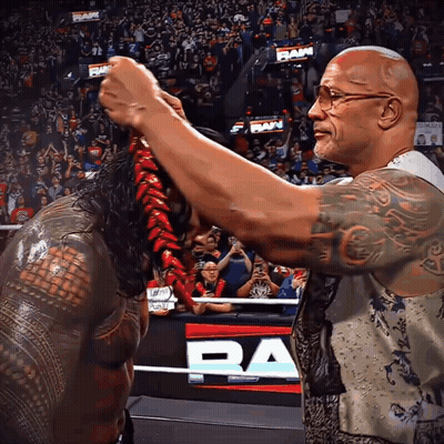 Two Wrestlers In Ring With Ram Banner GIF