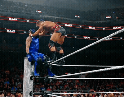 Two Wrestlers In Ring With Raw Behind Them GIF