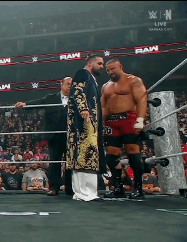Two Wrestlers In Ring With Raw GIF