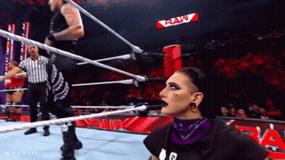 Two Wrestlers In Ring With Raw Sign GIF