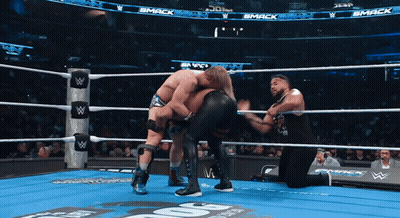 Two Wrestlers In Ring With Smack Sign GIF
