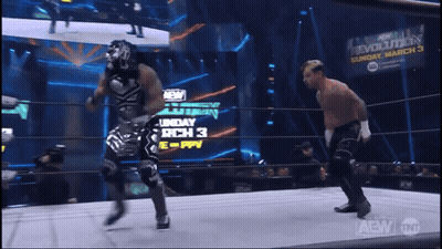 Two Wrestlers In Ring With Sunday March 3 Sign GIF