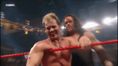 Two Wrestlers In Ring With W Logo GIF