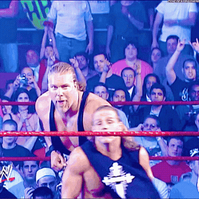 Two Wrestlers In Ring With W Logo GIF