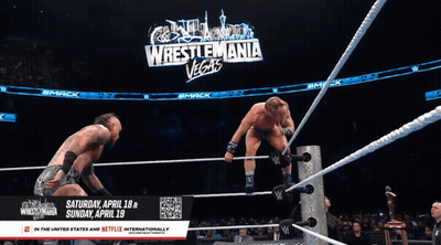 Two Wrestlers In Ring With Wrestlemania Vegas Sign GIF