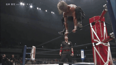 Two Wrestlers Laying On Floor With Chinese Writing GIF