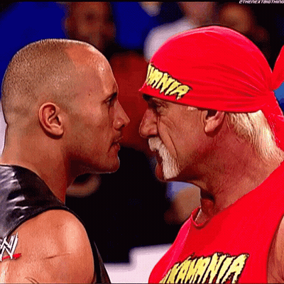 Two Wrestlers Looking At Each Other With One Wearing A Red Shirt That Says ' Kamina ' GIF