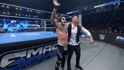 Two Wrestlers On A Wrestling Ring With The Word Smack In The Background GIF