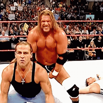 Two Wrestlers One With Cross Necklace GIF