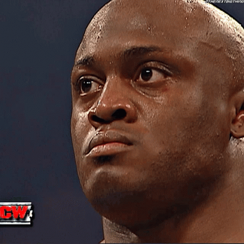 Two Wrestlers Standing In A Ring With A Yellow Shirt That Says Event Staff GIF