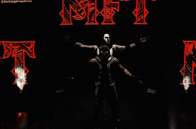 Two Wrestlers Standing In Front Of NFT Sign GIF