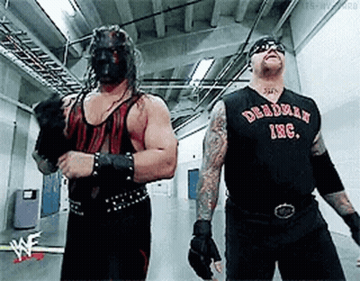 Two Wrestlers Standing Next To Each Other GIF