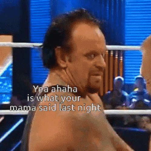 Two Wrestlers Standing Next To Each Other GIF