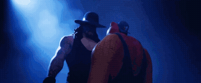 Two Wrestlers Standing Next To Each Other GIF