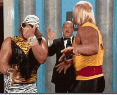 Two Wrestlers Standing Together One In Yellow Shirt GIF