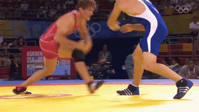 Two Wrestlers Wrestling In Front Of Askren USA Hung Sign GIF