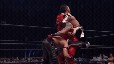 Two Wrestlers Wrestling In Ring With AEW Sign GIF
