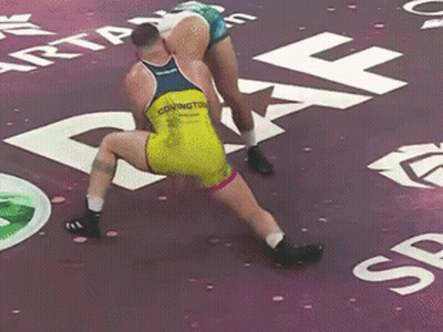 Two Wrestlers Wrestling On Purple Mat, One Named Covington GIF